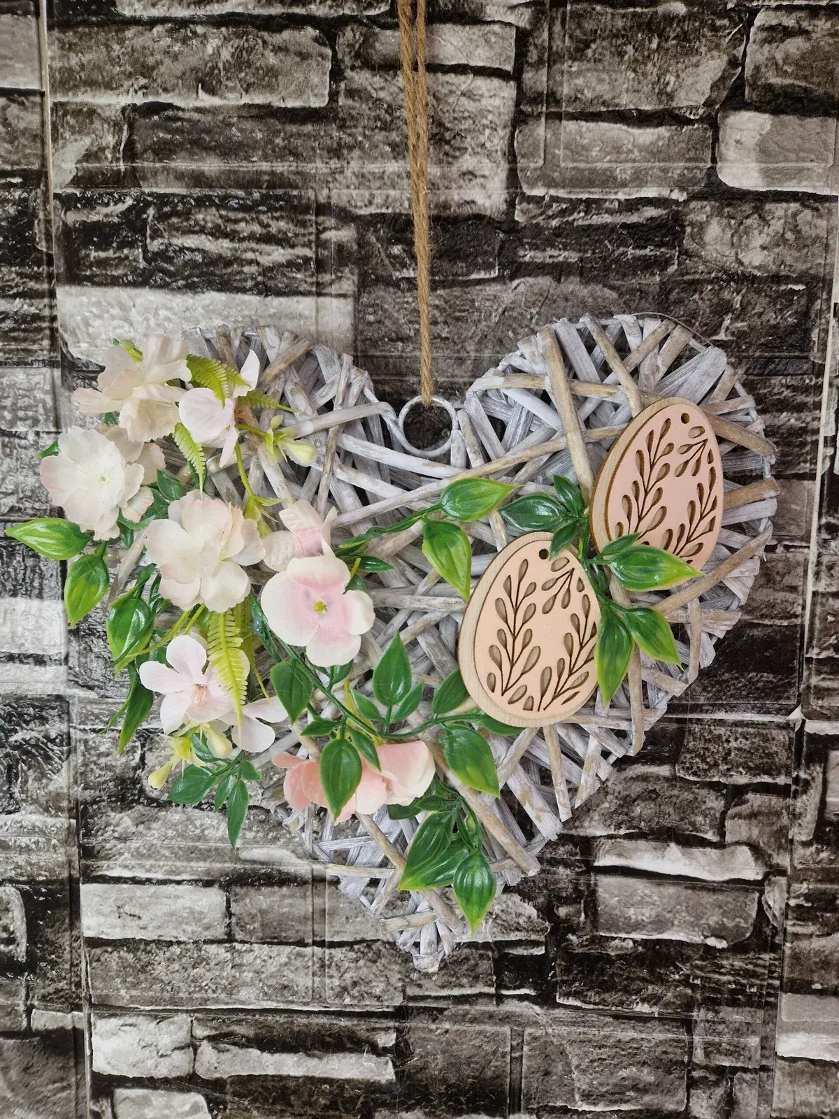 Handgefertigtes Weidenherz mit Blüten und Holzeiern